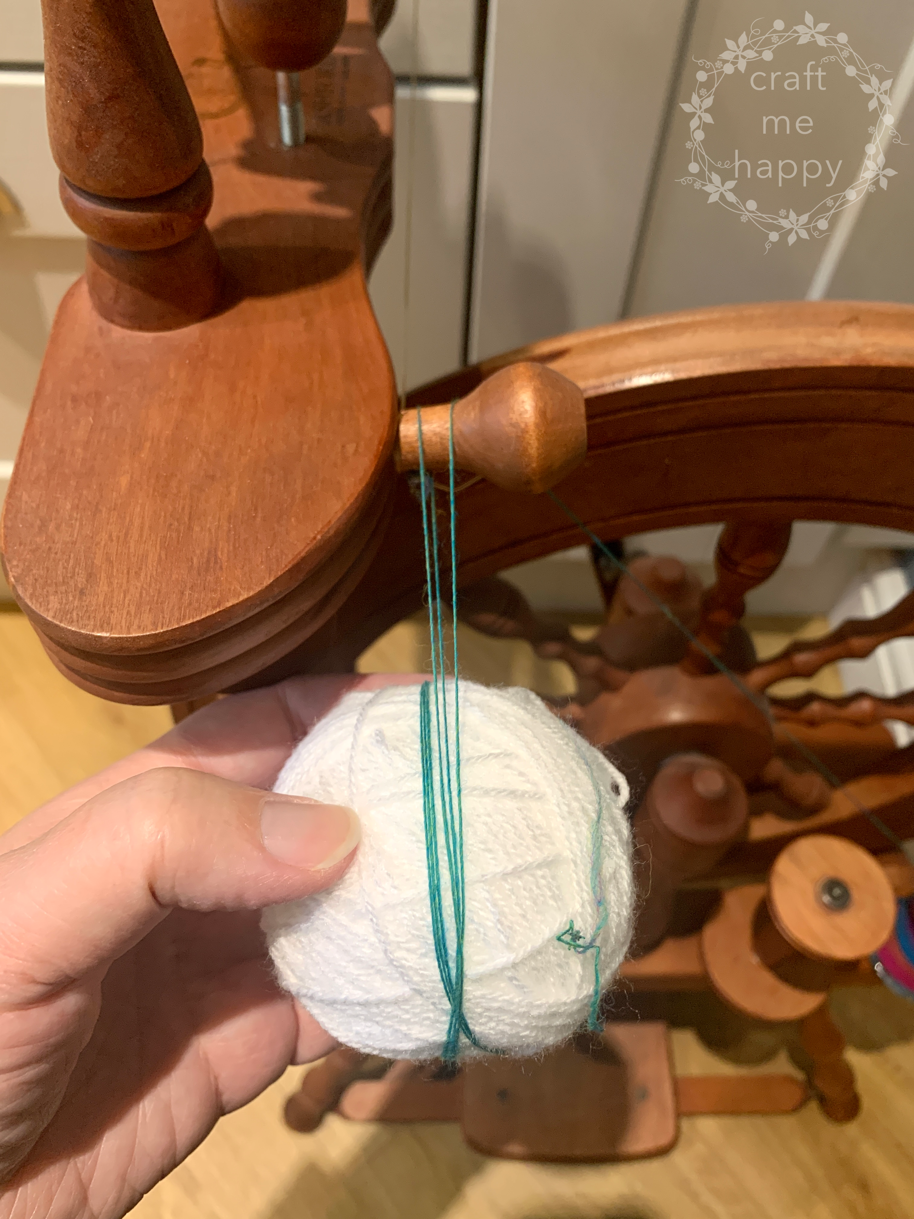 Spinning some hand-dyed wool into yarn using a wooden spinning wheel #