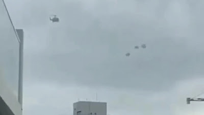 The best triple UFO sighting right next to an helicopter over a city centre filmed from an apartment window.