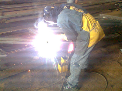 welder welding steel trusses