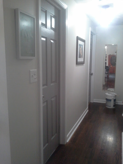 Hallway painted white trim grey doors