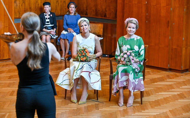 Queen Maxima wore a hand-painted silk and cotton shantung dress by Natan. Queen Mathilde wore a floral print maxi dress by Natan