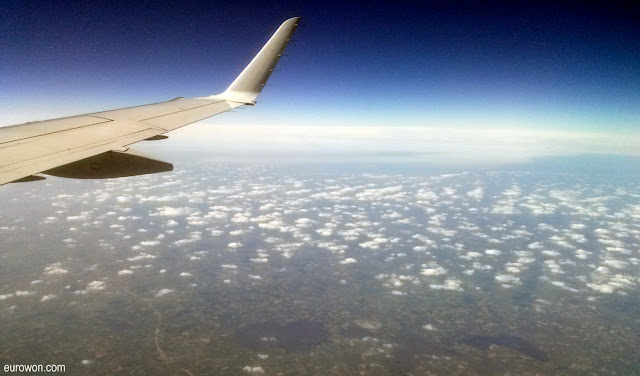 Avión sobrevolando nubes y lagos