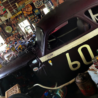 Old stock car is visible inside station.