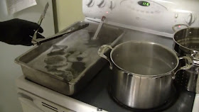 Parkerizing tray, solution and boiling water pot on stove.