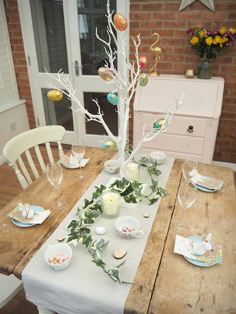 How to decorate a small dining room table and chairs for easter using decorative twig tree, plastic marble effect eggs, artificial ivy and mini eggs in teacups