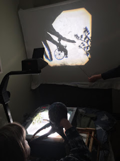 octopus puppet in shadow puppetry, putting wheelchair shadow puppet into the dark