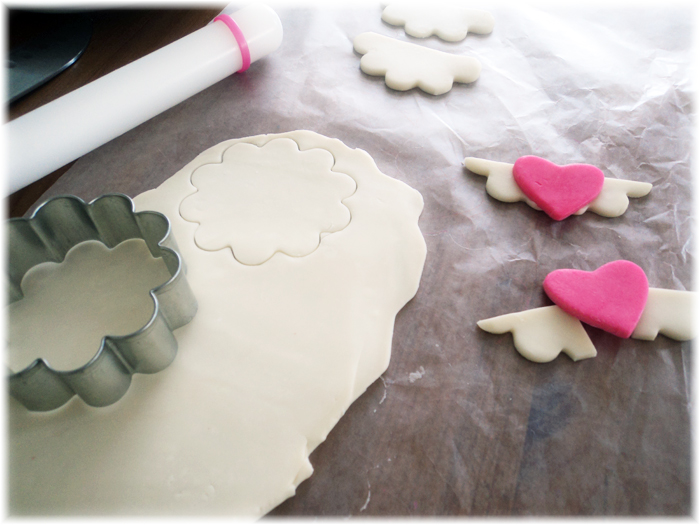 Making the angel wings with white and and pink chocolate candy clay