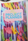 Cover of project planner showing multiple post it notes attached to a wall in bright colours