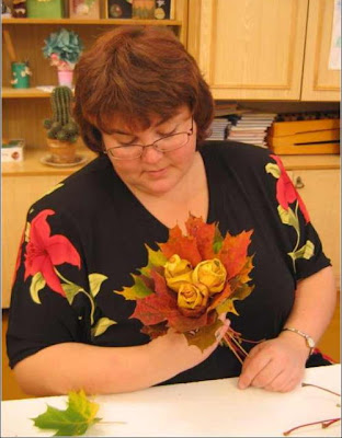 a woman creating a maple leaf flower craft