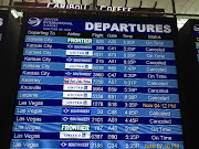 . connecting flights—a departure board lined out with canceled flights, . (denver airport display)