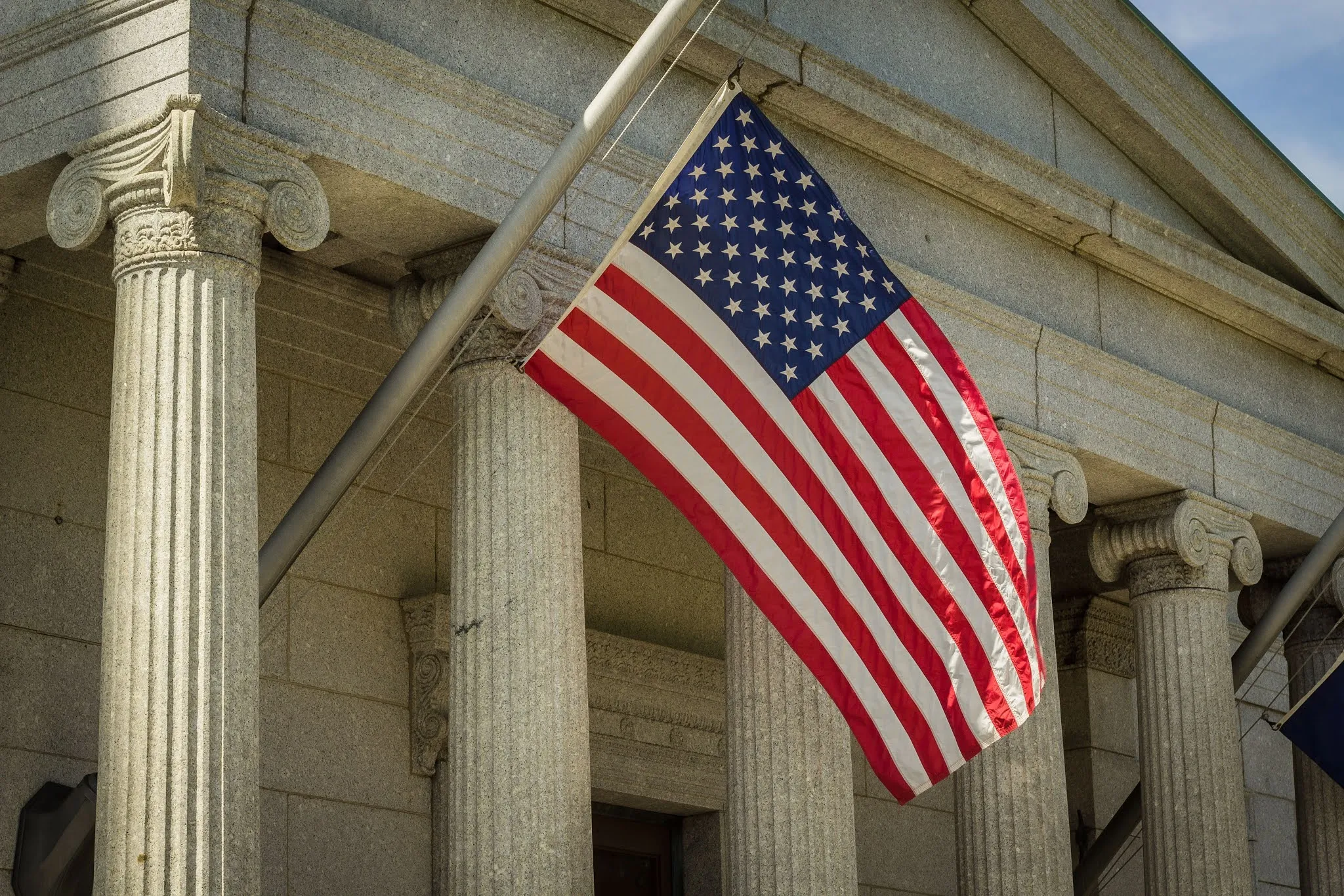 An American flag on a building in Boston CC0 image from Unsplash Bonnie Kittle