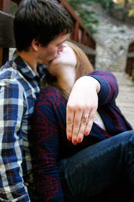 Alannah and Andrew kissing and showing engagement ring