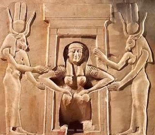 A squatting woman giving birth, assisted by two goddesses (Hathor and Taweret),  from the Temple of Hathor at Dendera 