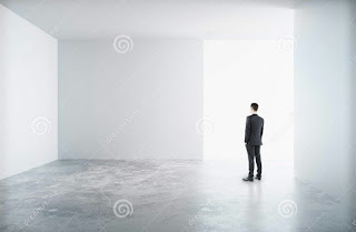 MAN STANDING IN AN EMPTY ROOM ALONE