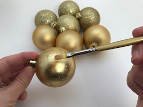 Painting baubles with gold glitter