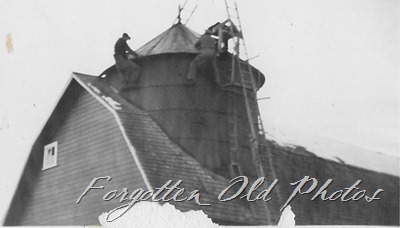 men on top of barn Verndale ant two