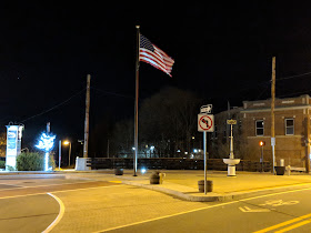 the US Flag on the downtown triangle at night
