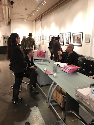 photo of Ed Kashi signing his book Abandonded Moments in Monroe Gallery, Santa Fe, NM