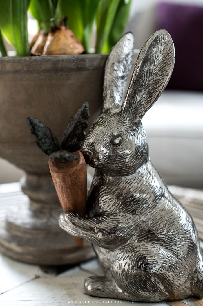 Silver rabbit holding wood carrot