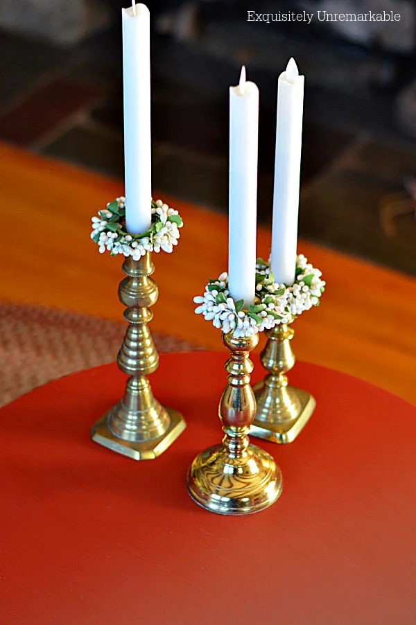 Brass Candlesticks On Red Table