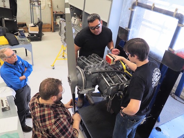 Team of students working on an airplane propeller