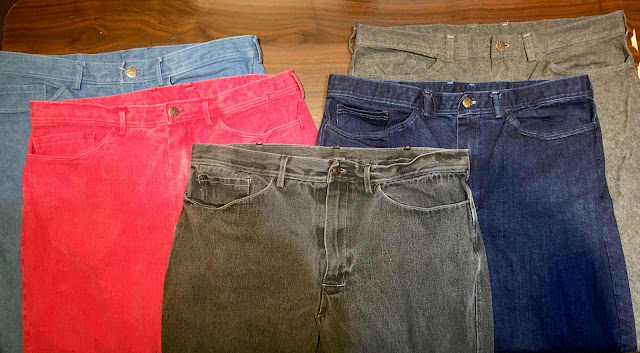 Five pair of jeans, light blue, red, dark gray, dark blue and medium gray.