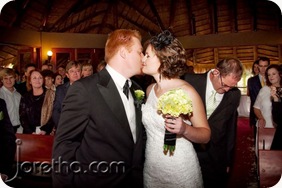 Bride and groom kiss in front of the altar at Galagos