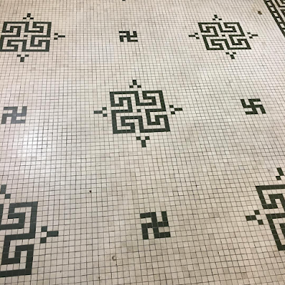 Black swastikas and tetraskelions in a floor mosaic at the Prahran Town Hall, Stonnington, Australia.