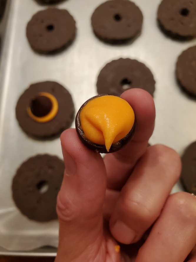 this is orange frosting on a hershey kiss to make a witch hat on shortbread cookies fudge strip