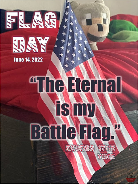 An American flag flies from the corner of a bed with a Minecraft wolf peering around the corner. Text overlay reads: "Flag Day: June 14, 2022. 'The Eternal is my Battle Flag.' Exodus 17:15