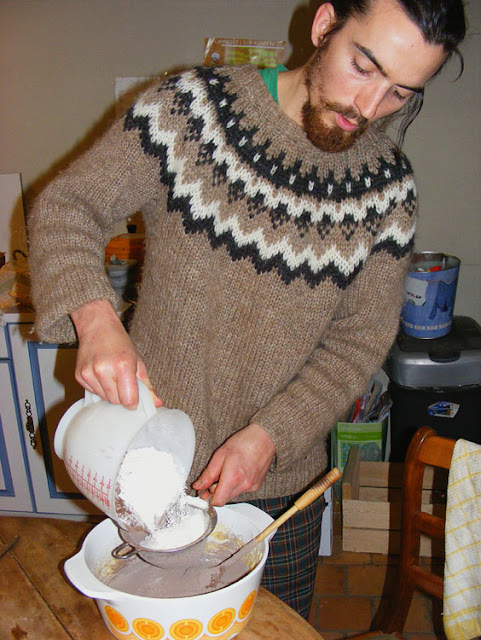 Sifting flour and cocoa into cake batter.  Indre et Loire, France. Photographed by Susan Walter. Tour the Loire Valley with a classic car and a private guide.