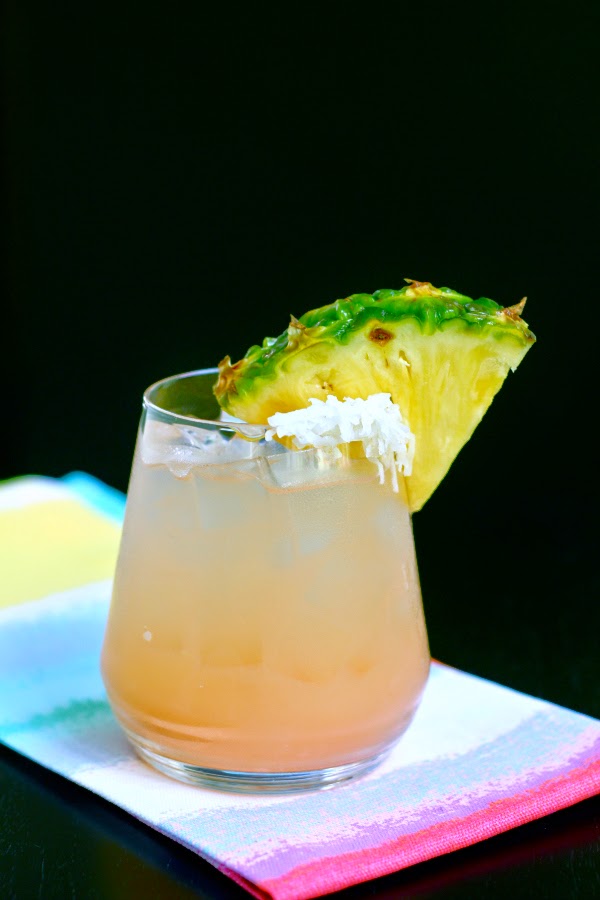 peach cocktail with pineapple coconut garnish