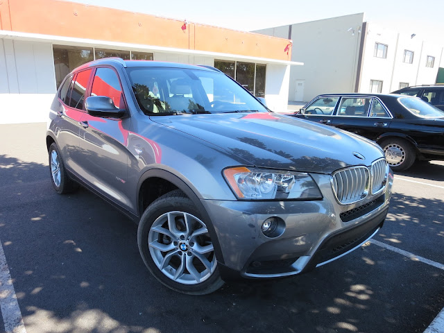 BMW X3 with scraped bumper before repairs at Almost Everything Auto Body.