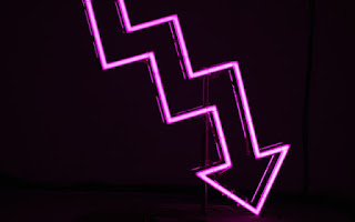 Downward pointing pink arrow neon sign by Ussama Azam via Unsplash - https://unsplash.com/photos/26h317_UMYM