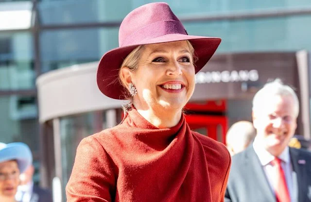 Queen Maxima wore a red midi dress from Natan. The Queen wore a new burgundy hat by Maison Michel Paris