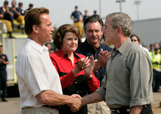 President George W. Bush shakes hands with California Governor Arnold Schwarzenegger as he talks with the media after touring the Rancho Bernardo neighborhood Thursday, Oct. 25, 2007, with Senator Dianne Feinstein, D-Calif., and FEMA Director David Paulison. Said the President: 'To the extent that people need help from the federal government, we will help... My job is to make sure that FEMA and the Defense Department and the Interior Department and Ag Department respond in a way that helps people get the job done.' White House photo by Eric Draper