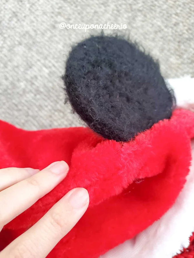 Stitch the Mouse Ears to the side of seams of the Santa hat