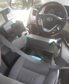 An image of a vehicle and high tech, adaptive driving solutions. Behind the steering wheel, a joystick is located on the left side and a throttle mechanism is located on the right