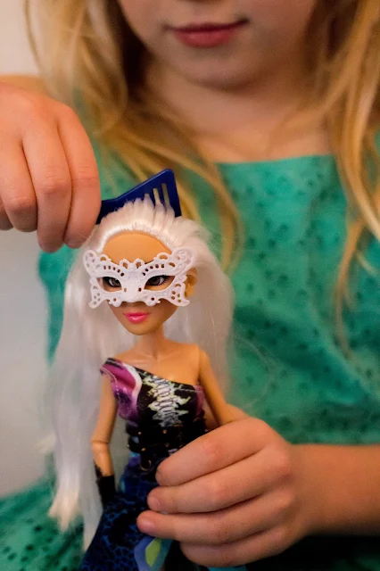 A close up of the Project Mc2 Camryn doll having her hair combed