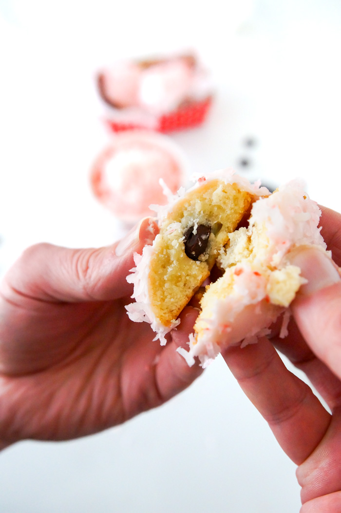 pink snowball cookies, in man's hands, revealing chocolate center