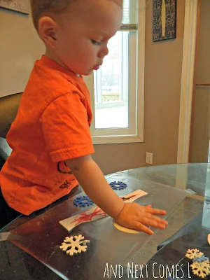 K working on his sticky winter collage from And Next Comes L