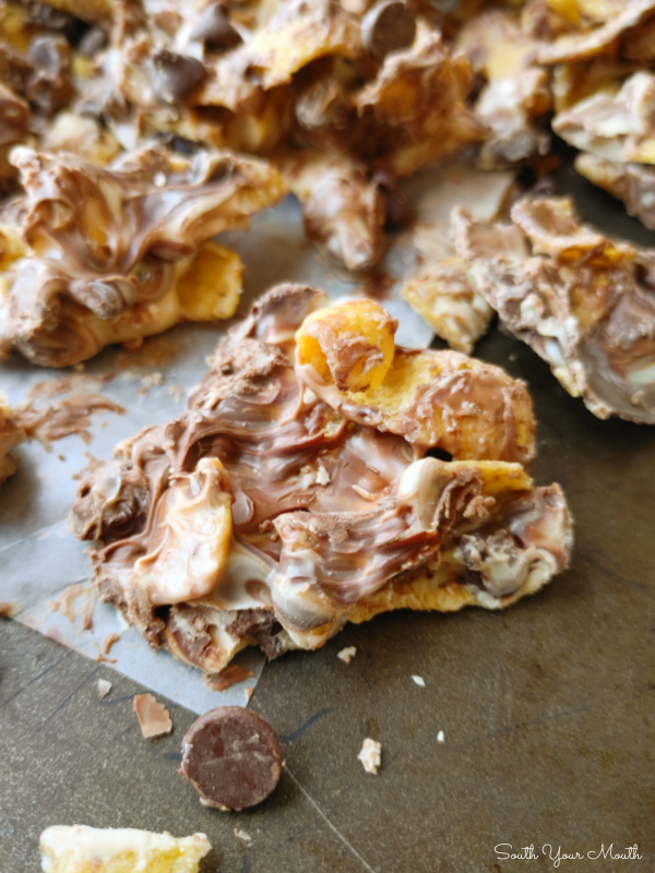 Peanut Butter Chocolate Frito Munch! A quick 4-ingredient sweet and salty recipe of Fritos corn chips and chocolate morsels covered in white chocolate and peanut butter then cooled into a candy bark.