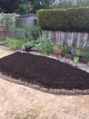 Filling the bed with topsoil and compost