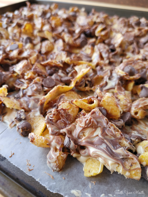 Peanut Butter Chocolate Frito Munch! A quick 4-ingredient sweet and salty recipe of Fritos corn chips and chocolate morsels covered in white chocolate and peanut butter then cooled into a candy bark.