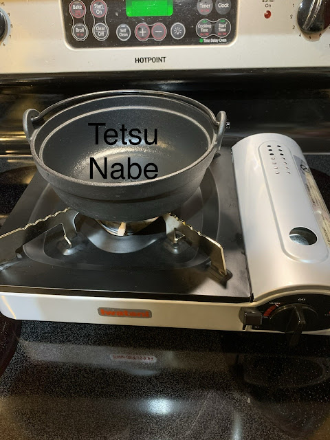 small cast iron cooking pot labeled “tetsu nabe”