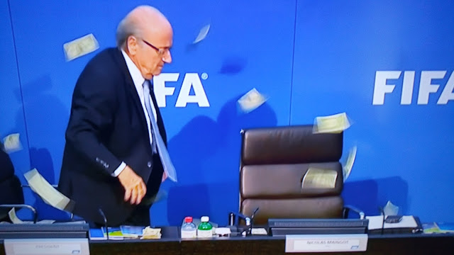 Money thrown at Sep Blatter during press conference!