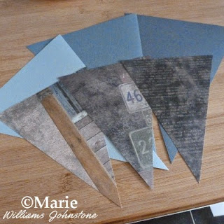3 plain gray triangle flag sections with 3 scrapbook paper pieces