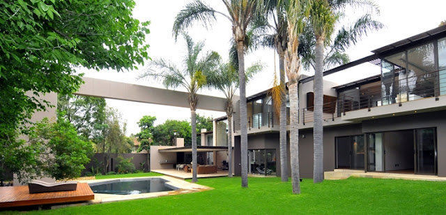 Picture of large modern mansion as seen from the backyard