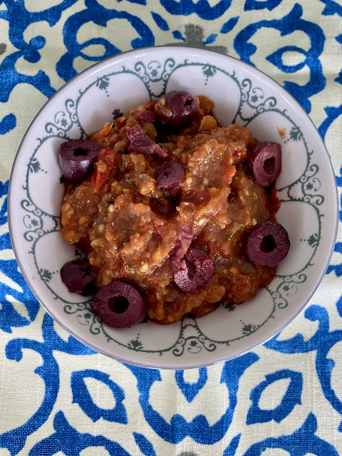 bowl of eggplant dip with olives