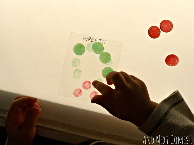 Putting glass stones on a wreath template on the light table